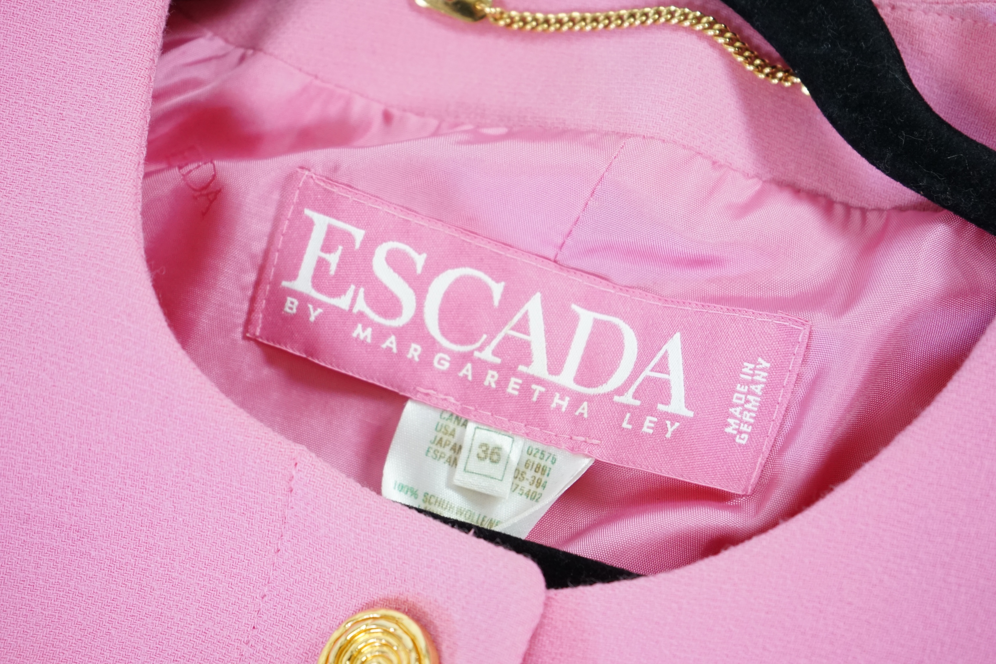 A pink Escada suit with a silk blouse top. Proceeds to Happy Paws Puppy Rescue